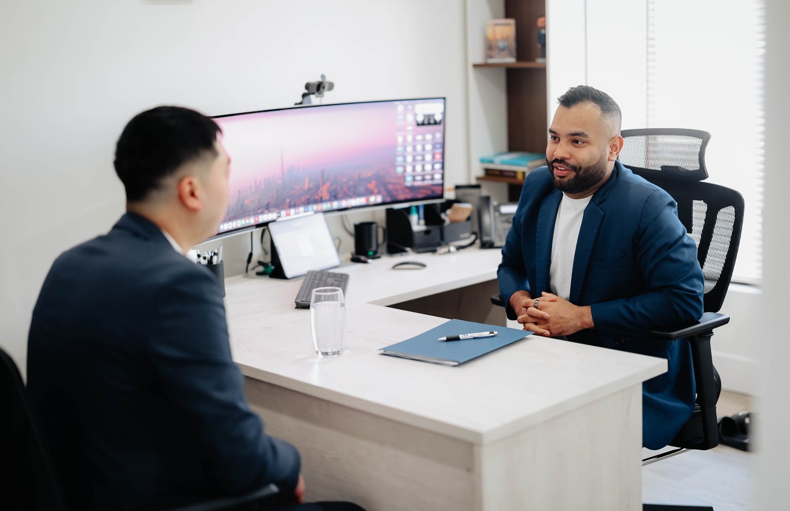 Rahul Bedi meeting with a client across his desk at the Team Active Mortgage office
