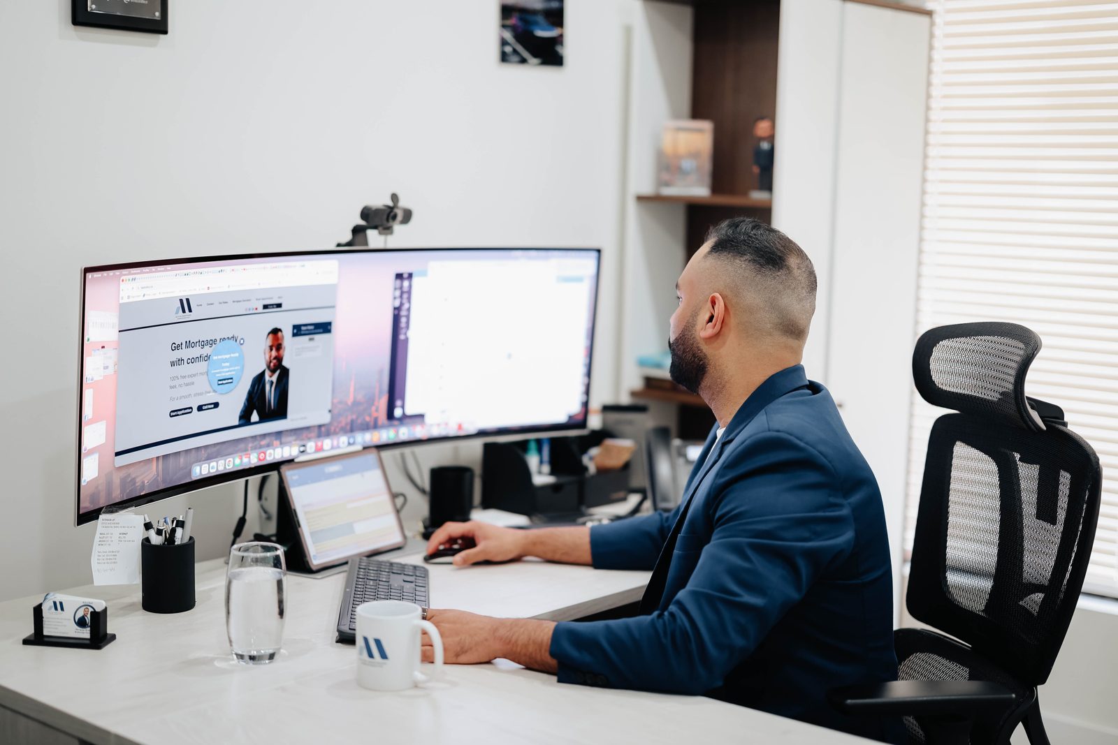 Rahul Bedi at his desk with the Active Mortgage website on screen