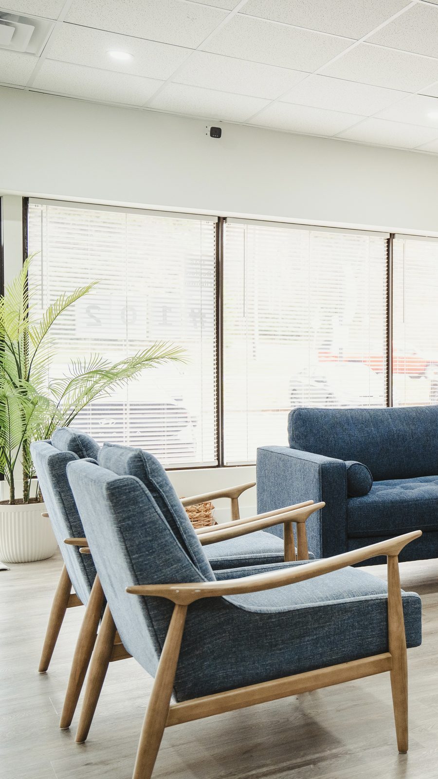 Bright seating area with navy armchairs at the Team Active Mortgage Bedford office